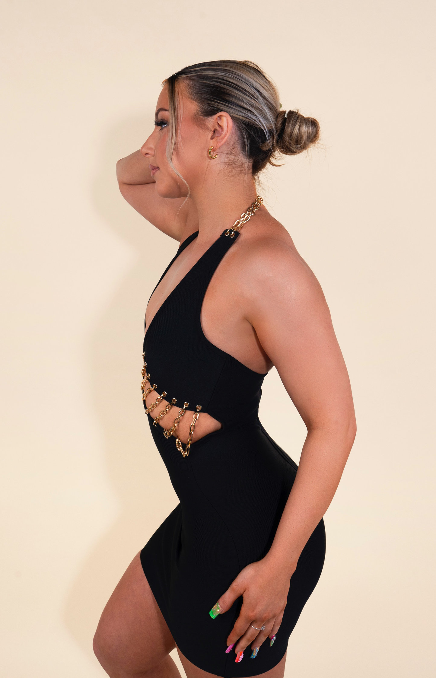 Black bandage mini dress with front cut out and embellished chain